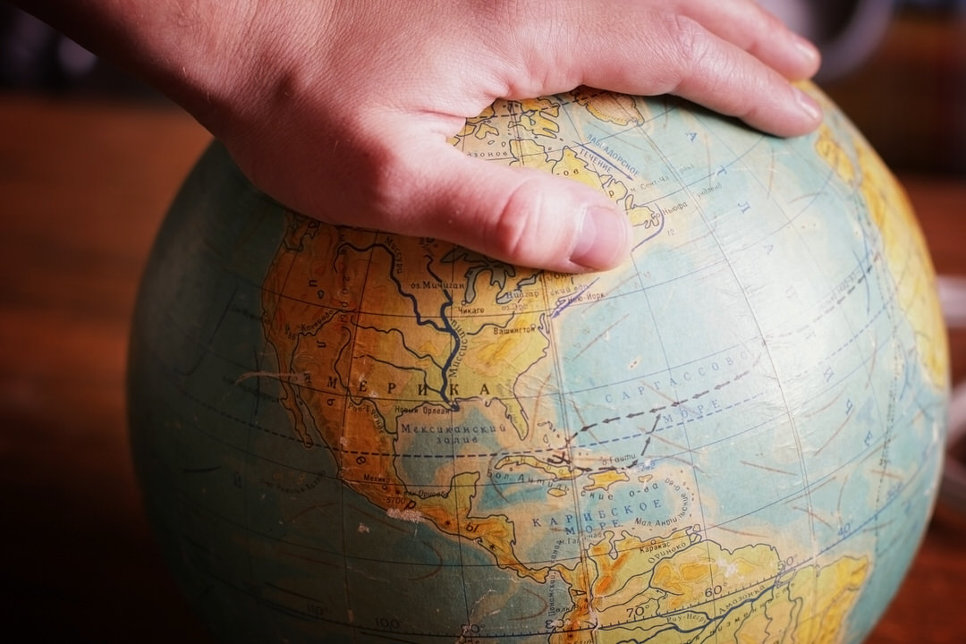 hand on globe